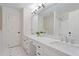 Bright bathroom featuring a double vanity with stone countertop and updated fixtures at 300 Livingstone Dr, Cary, NC 27513