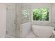 Elegant bathroom featuring a glass-enclosed shower, soaking tub, and luxurious finishes at 300 Livingstone Dr, Cary, NC 27513