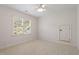 Bright bedroom with neutral colors, carpet, ceiling fan, and a large window at 300 Livingstone Dr, Cary, NC 27513