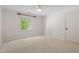 Well-lit bedroom featuring neutral colors, a ceiling fan, and a large window at 300 Livingstone Dr, Cary, NC 27513