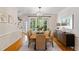 Formal dining room with a modern light fixture, large windows and hardwood flooring at 300 Livingstone Dr, Cary, NC 27513
