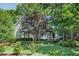 Well-maintained home featuring lush landscaping, a green lawn and mature trees at 300 Livingstone Dr, Cary, NC 27513
