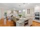 Open-concept kitchen with granite island, stainless steel appliances, and adjacent living space at 300 Livingstone Dr, Cary, NC 27513