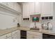 Laundry room with granite counters, white cabinets and ample storage space at 300 Livingstone Dr, Cary, NC 27513