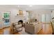 Bright living room featuring hardwood floors, fireplace, and French doors to outdoor living area at 300 Livingstone Dr, Cary, NC 27513
