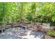Outdoor kitchen and patio area featuring built-in seating, stone accents, and a built-in grill at 300 Livingstone Dr, Cary, NC 27513