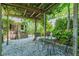 Charming outdoor space with a stone patio, pergola, and lush greenery at 300 Livingstone Dr, Cary, NC 27513