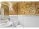 Stylish powder room with elegant wallpaper, white wainscoting, and a modern sink at 300 Livingstone Dr, Cary, NC 27513
