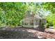 Back of the house with a screened porch, stone retaining wall and landscaping at 300 Livingstone Dr, Cary, NC 27513