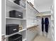 Organized walk-in closet with custom shelving for clothing, shoes and accessories at 300 Livingstone Dr, Cary, NC 27513