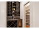 Wine room with custom shelving and a wine refrigerator at 300 Livingstone Dr, Cary, NC 27513