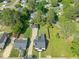An aerial view of a well-manicured backyard with lush green lawn and detached garage at 305 E Holmes St, Benson, NC 27504