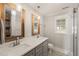 Elegant bathroom featuring a double vanity, modern fixtures, and a glass-enclosed shower at 305 E Holmes St, Benson, NC 27504