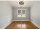 Cozy bedroom with hardwood floors, beadboard ceiling, and a ceiling fan fixture at 305 E Holmes St, Benson, NC 27504