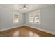 Bedroom with hardwood floors, beadboard ceiling and two large windows providing natural light at 305 E Holmes St, Benson, NC 27504