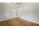 Bedroom with hardwood floors, beadboard ceiling, ceiling fan and access to closet at 305 E Holmes St, Benson, NC 27504