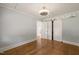 Bright bedroom features beautiful wood floors and access to closet via sliding barn doors at 305 E Holmes St, Benson, NC 27504