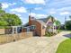 Side view of a brick home with a screened-in porch and mature landscaping at 305 E Holmes St, Benson, NC 27504