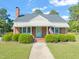 Charming brick home with a well-manicured front yard and American flag at 305 E Holmes St, Benson, NC 27504