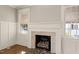 Elegant fireplace with a decorative mantel, a patterned hearth, and large windows offering natural light at 305 E Holmes St, Benson, NC 27504