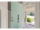 View through the front door showing the covered porch, manicured lawn and landscape, and the street beyond at 305 E Holmes St, Benson, NC 27504