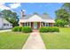 Charming brick home with manicured lawn, walkway, and covered entrance, creating an inviting curb appeal at 305 E Holmes St, Benson, NC 27504
