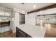 Bright eat-in kitchen features stainless refrigerator, central island and sliding door pantry at 305 E Holmes St, Benson, NC 27504