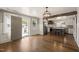 Living room leading to the kitchen with stainless steel appliances, a central island, and abundant natural light at 305 E Holmes St, Benson, NC 27504