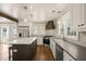 Open concept eat-in kitchen features stainless appliances, white cabinets, island and farmhouse sink at 305 E Holmes St, Benson, NC 27504
