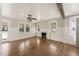 Bright living room with hardwood floors, a fireplace with a mantel, and lots of natural light from large windows at 305 E Holmes St, Benson, NC 27504