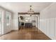 Hardwood floors in the living room flowing into the kitchen area with a central island and stainless steel appliances at 305 E Holmes St, Benson, NC 27504