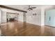 Open concept living room with hardwood floors, leading into the kitchen area featuring a rustic beam at 305 E Holmes St, Benson, NC 27504