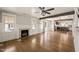 Spacious living room with a fireplace, an exposed beam, hardwood floors, and an open layout to the kitchen at 305 E Holmes St, Benson, NC 27504