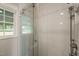 Modern shower with white subway tile, glass door and seat, and chrome shower head at 305 E Holmes St, Benson, NC 27504