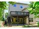 A large deck overlooks the backyard. Stairs lead to a patio area at 306 Mainline Station Dr, Morrisville, NC 27560