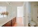 Bathroom featuring double sinks, cherry cabinets, and a large mirror at 306 Mainline Station Dr, Morrisville, NC 27560