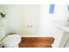 Cozy half-bathroom featuring a pedestal sink and a modern toilet next to a small shelf at 306 Mainline Station Dr, Morrisville, NC 27560