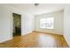 Bright bedroom with wood floors and a view of the bathroom at 306 Mainline Station Dr, Morrisville, NC 27560