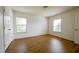 Bright bedroom features wood-look flooring, natural light from two windows and neutral walls at 306 Mainline Station Dr, Morrisville, NC 27560