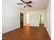 Bedroom showcasing wood-look floors, ceiling fan, and doors leading to other rooms at 306 Mainline Station Dr, Morrisville, NC 27560