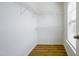 Walk-in closet with ventilated shelving and wood floors at 306 Mainline Station Dr, Morrisville, NC 27560