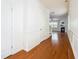 Inviting hallway featuring hardwood floors and detailed wainscoting leading into a bright living space at 306 Mainline Station Dr, Morrisville, NC 27560