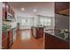 This kitchen features an island, stainless steel appliances, and wood floors at 306 Mainline Station Dr, Morrisville, NC 27560