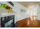 Living room with dark fireplace, hardwood floors, and lots of sunlight at 306 Mainline Station Dr, Morrisville, NC 27560