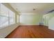 Large living area with hardwood floors and many windows providing plenty of natural light at 306 Mainline Station Dr, Morrisville, NC 27560