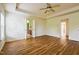 Large main bedroom featuring neutral walls, wood floors, trey ceilings, and ceiling fan at 306 Mainline Station Dr, Morrisville, NC 27560