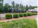 A black, metal fence surrounds the community pool at 306 Mainline Station Dr, Morrisville, NC 27560