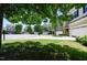 View of a well-maintained street showing multiple homes with manicured lawns and attached garages at 306 Mainline Station Dr, Morrisville, NC 27560