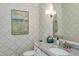 A half bathroom featuring patterned wallpaper, a vessel sink, marble countertop, and artwork at 318 Ivy Ridge Rd, Chapel Hill, NC 27516