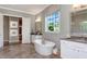 A luxurious bathroom with a soaking tub, double vanity, and lots of natural light at 318 Ivy Ridge Rd, Chapel Hill, NC 27516